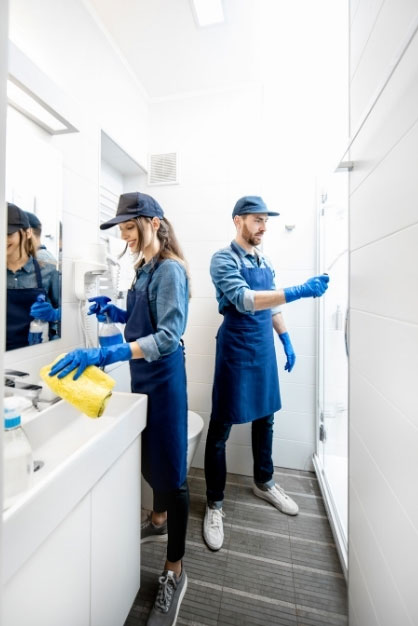 Commercial cleaners sanitising an office bathroom in Melbourne